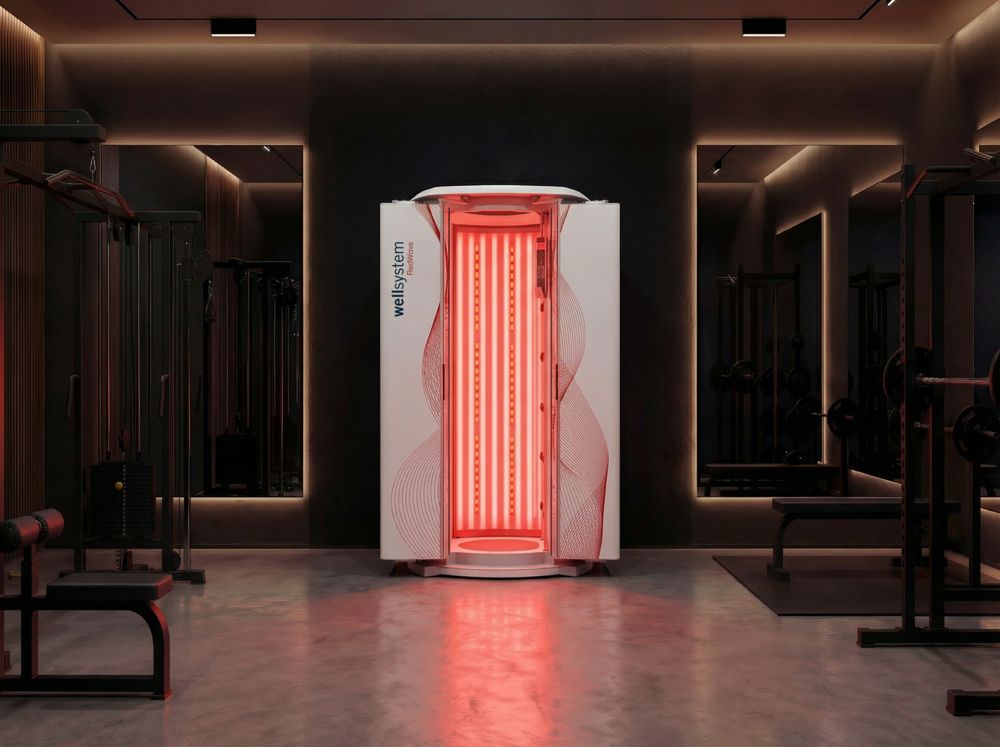 Upright RedWave booth lit red inside a dark gym
