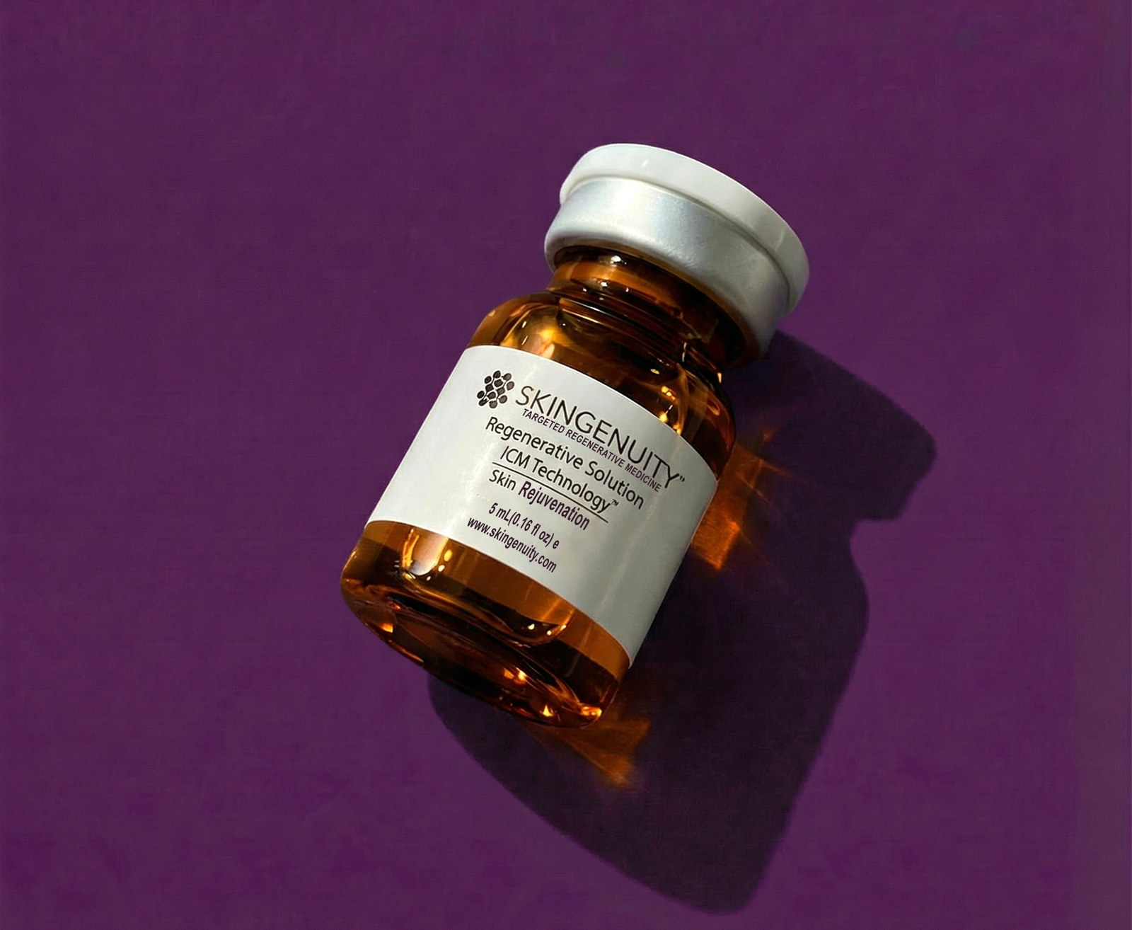 Skingenuity Regenerative Solution vial for skin rejuvenation, on a violet studio backdrop
